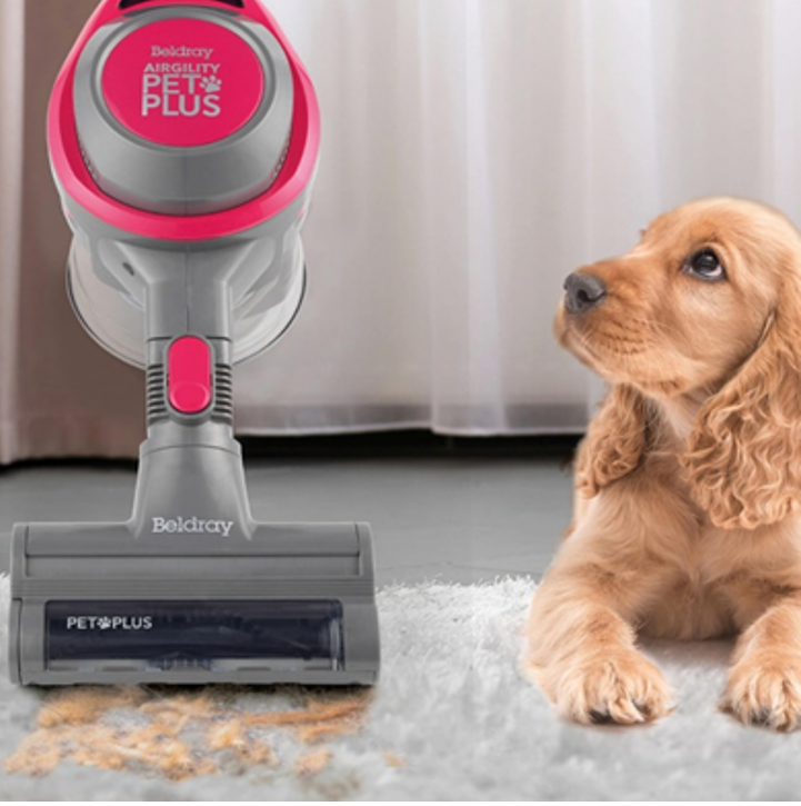 A Pet plus vacuum cleaner being used to suck up dog hair