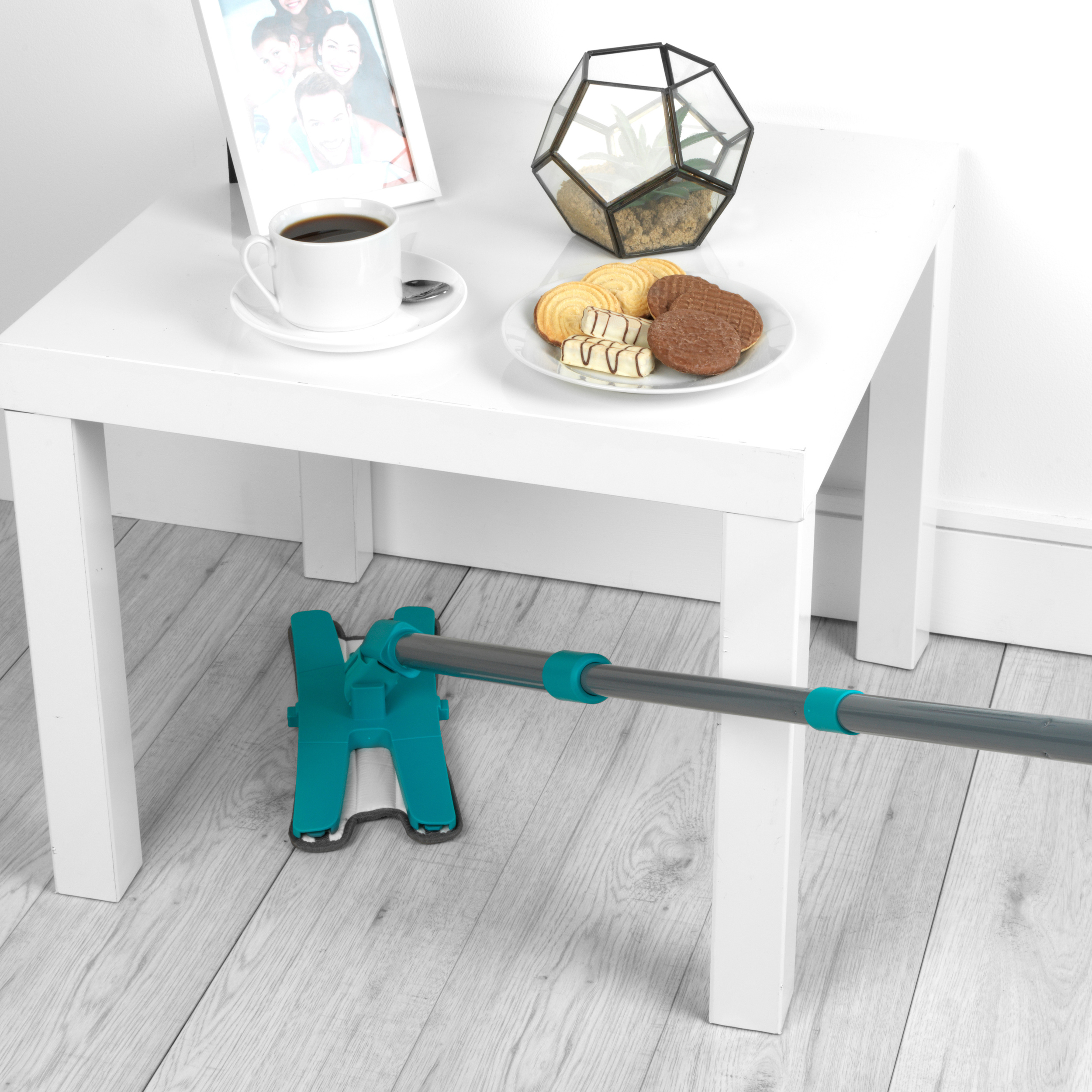 Beldray pet Plus TPR Mop being used under a low white table