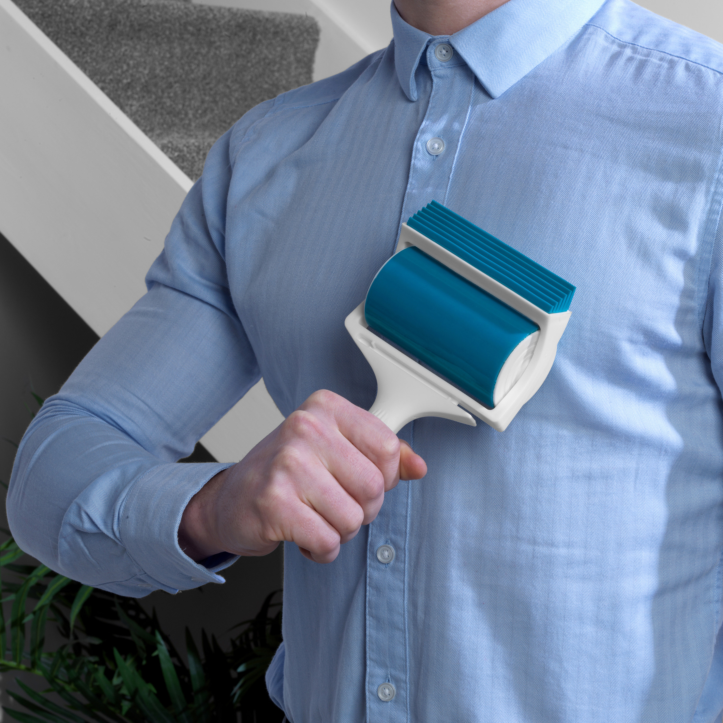 A Beldray Pet Plus Gel Lint Roller being used on a mans shirt